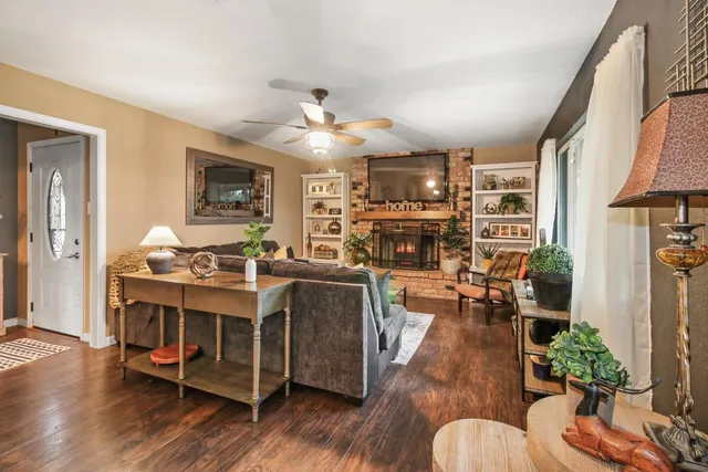 a living room with furniture kitchen view and a fireplace