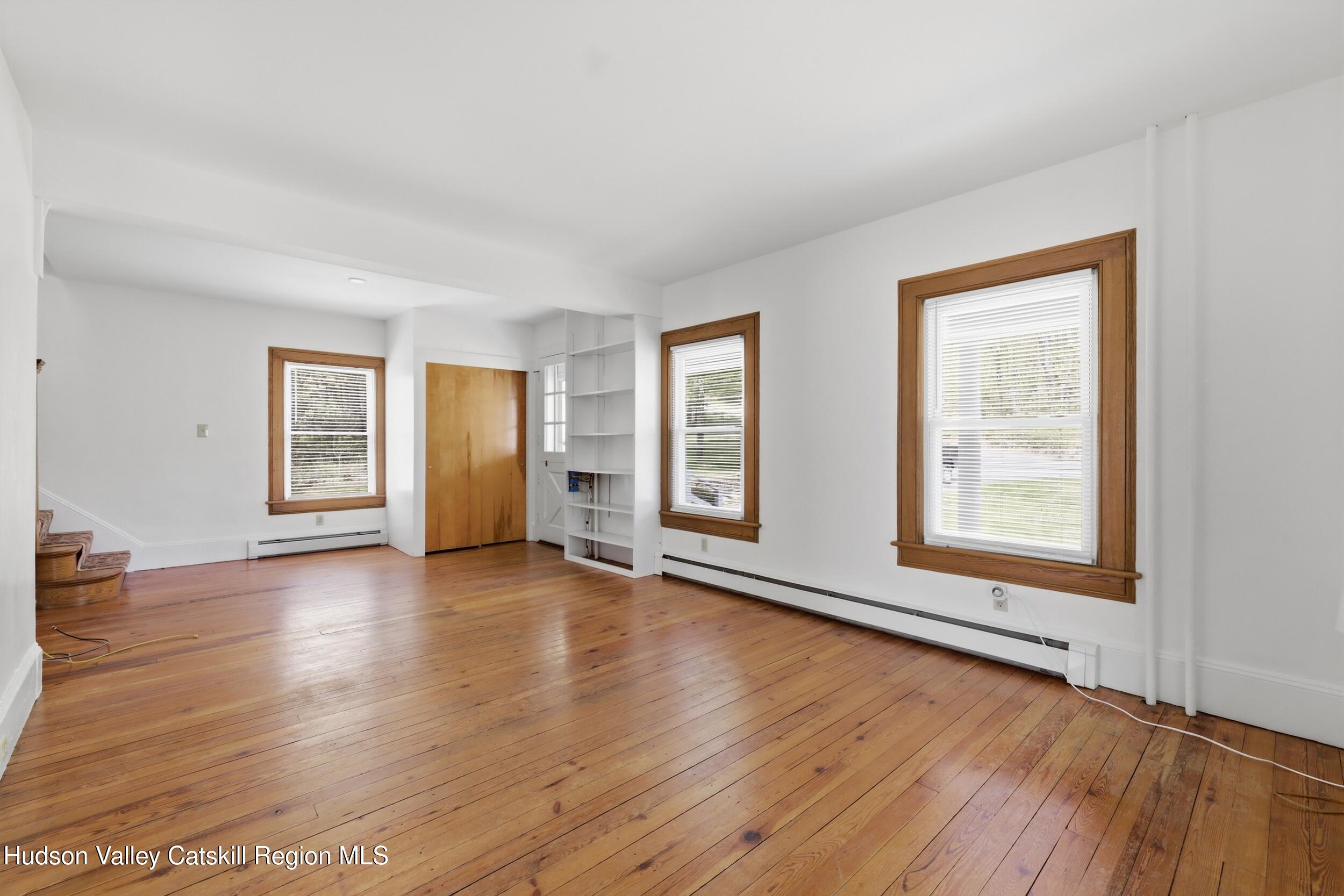 294 Kyserike Road Accord, NY 12404 - Photo 7 of 46 an empty room with wooden floor and windows