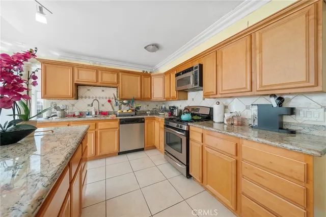a kitchen with cabinets and chairs