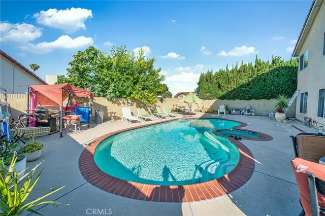 a backyard of a house with table and chairs