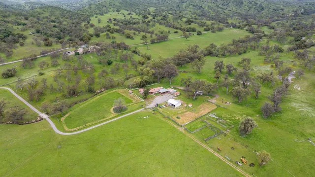 an aerial view of a residential houses with outdoor space