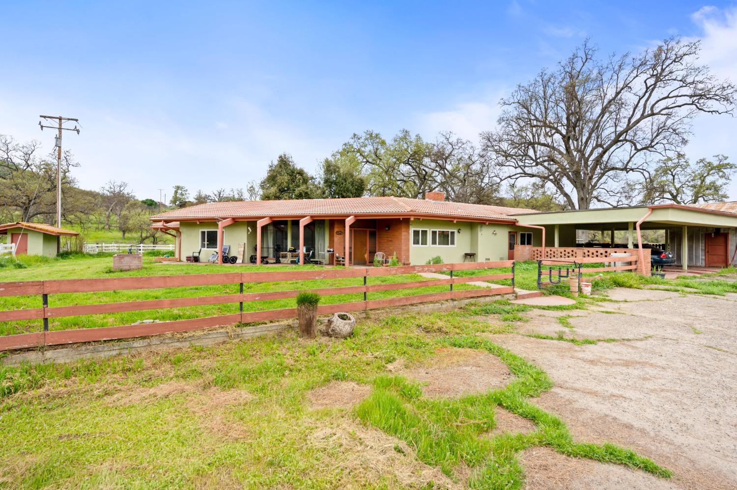 53660 Drive 152 Orosi, CA 93647 - Photo 26 of 48 a front view of a house with a yard table and chairs