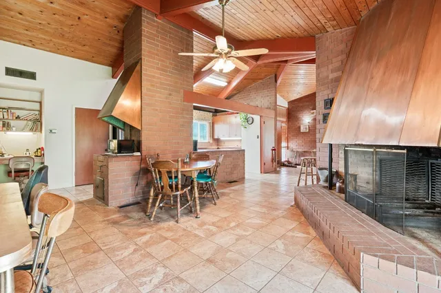 a large kitchen with stainless steel appliances granite countertop a sink and cabinets
