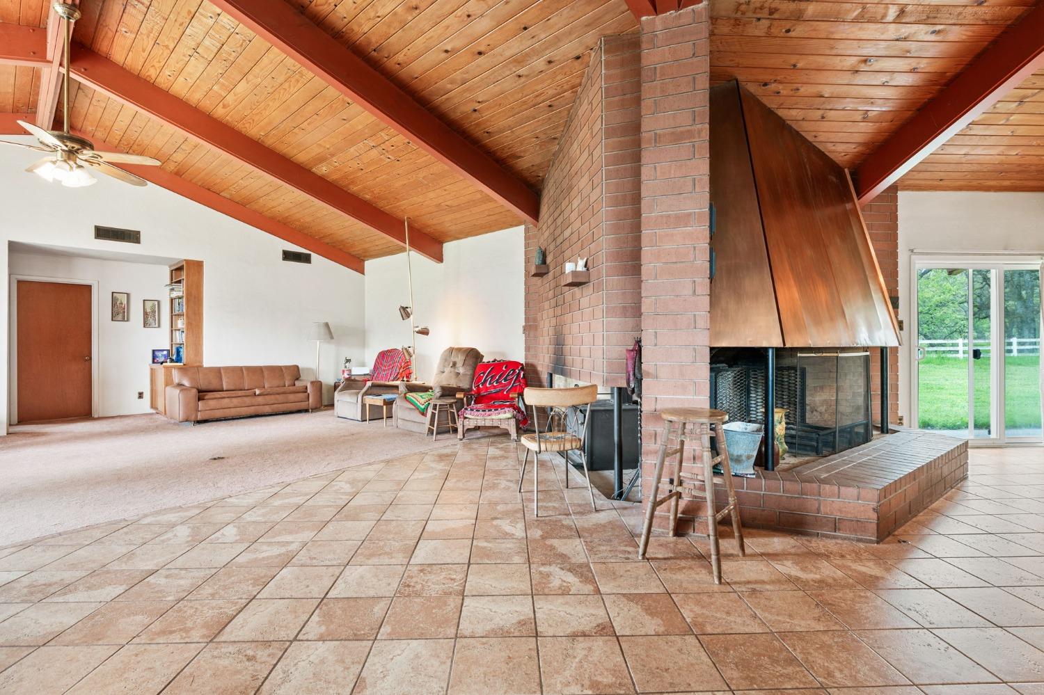 53660 Drive 152 Orosi, CA 93647 - Photo 37 of 48 a view of a patio with table and chairs under an umbrella with a barbeque