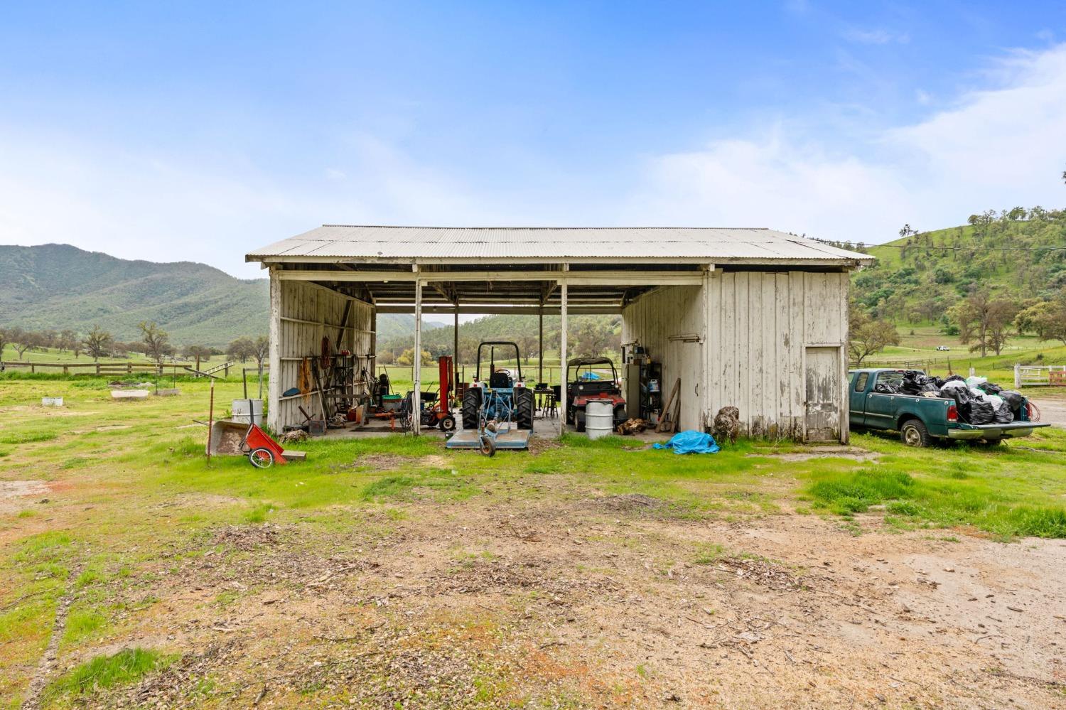 53660 Drive 152 Orosi, CA 93647 - Photo 38 of 48 a view of a patio with table and chairs under an umbrella