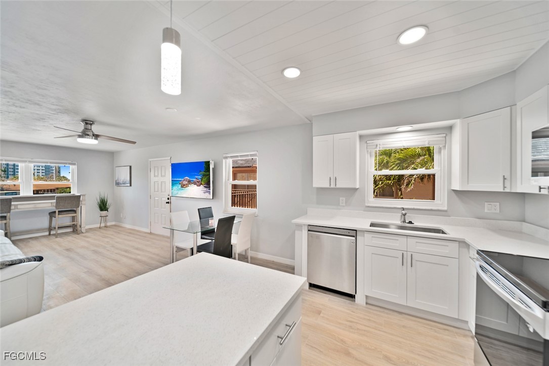 16881 Davis Road, Unit 721 Fort Myers, FL 33908 - Photo 11 of 23 a kitchen with lots of counter top space and painting on the wall