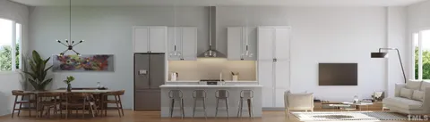 a kitchen with cabinets and wooden floor