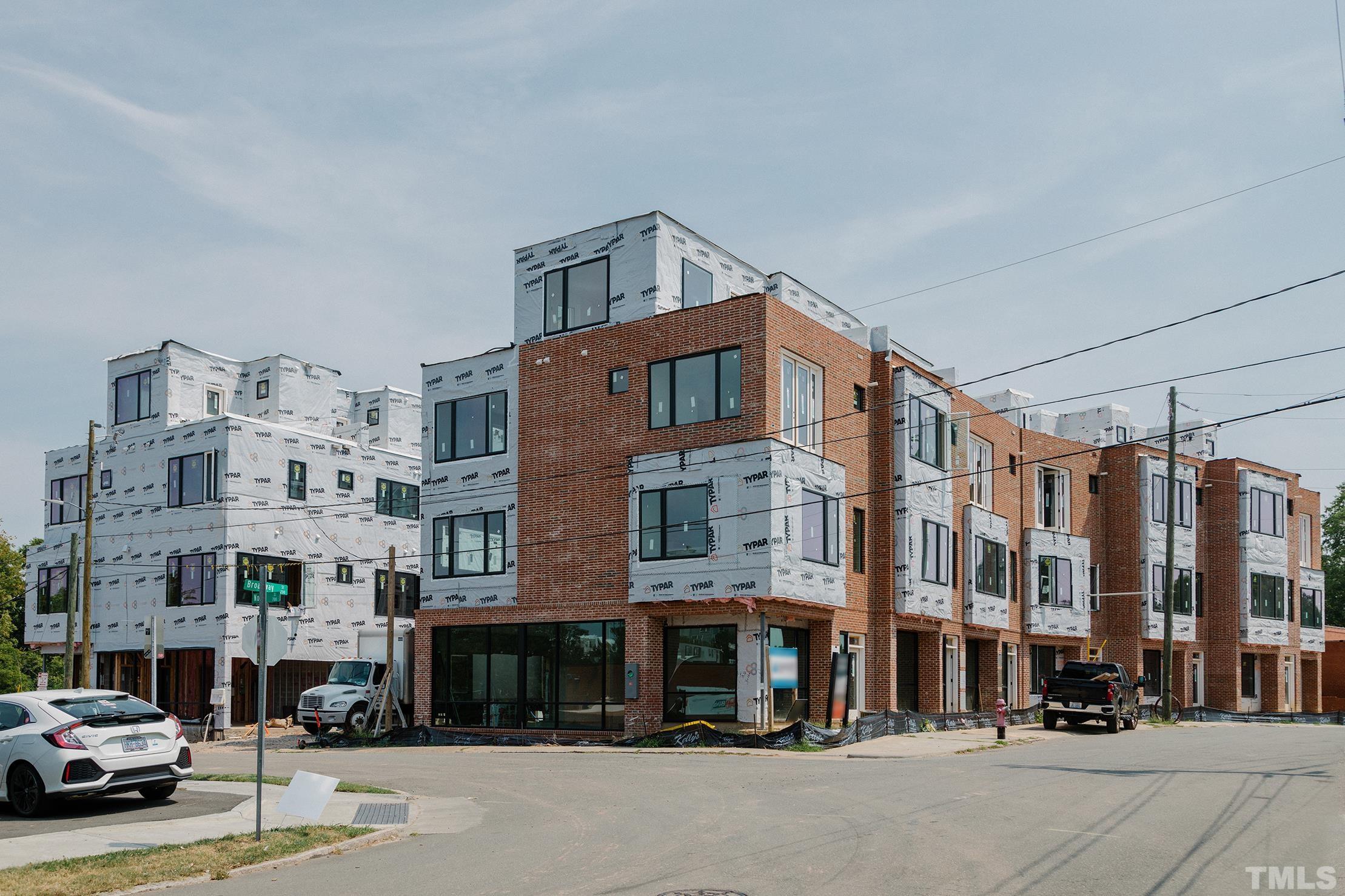 3007 Corbell Road Durham, NC 27701 - Photo 2 of 30 a city street lined with buildings and a cars parked on the street