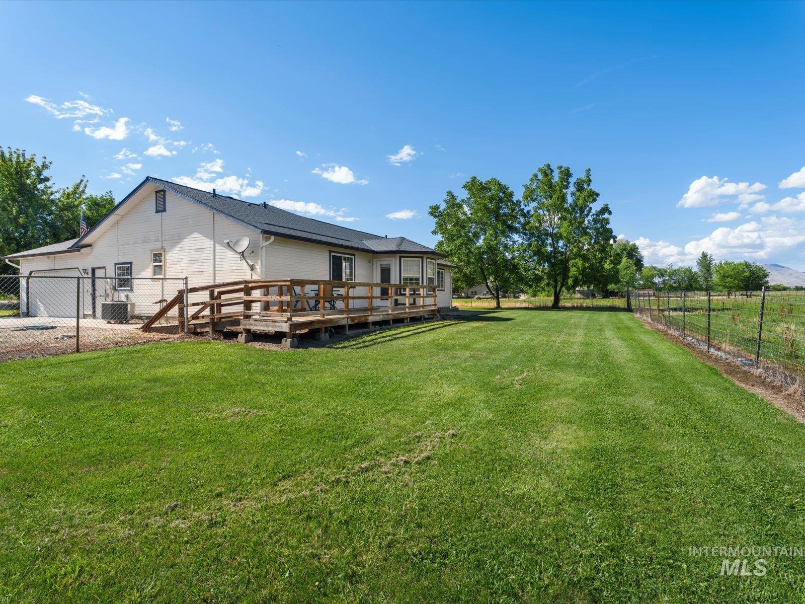3540 Wills Road Emmett, ID 83617 - Photo 31 of 36 Expansive green lawn with a wooden deck and ramp