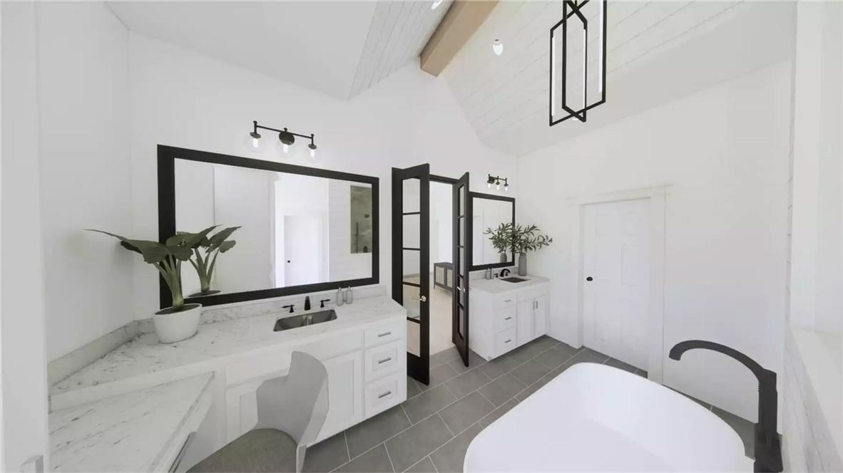 204 Rogers Road Pendleton, SC 29670 - Photo 11 of 12 This bright bathroom features dual vanities and a freestanding tub, offering a serene personal retreat.