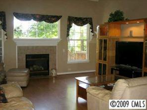 328 Brixham Place Fort Mill, SC 29708 - Photo 3 of 8 a living room with furniture a flat screen tv and a fireplace