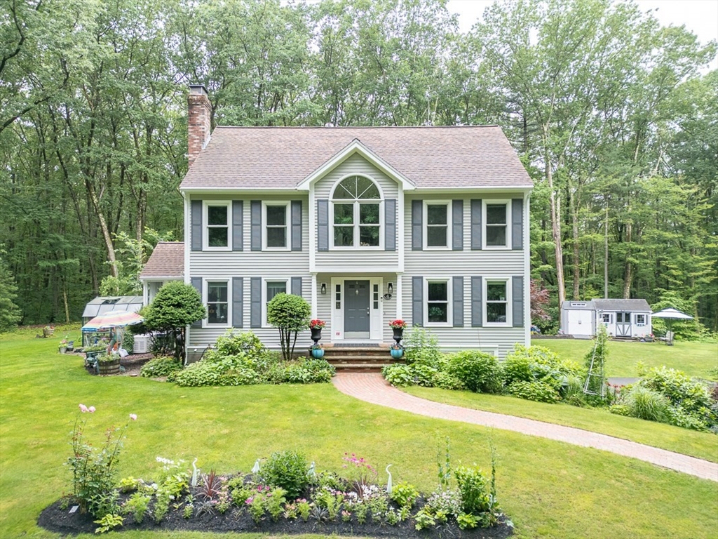 4 Wilderness Way Pepperell, MA 01463 - Photo 1 of 42 a front view of a house with a garden