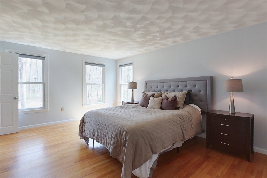 4 Wilderness Way Pepperell, MA 01463 - Photo 19 of 42 a bedroom with a bed and a window