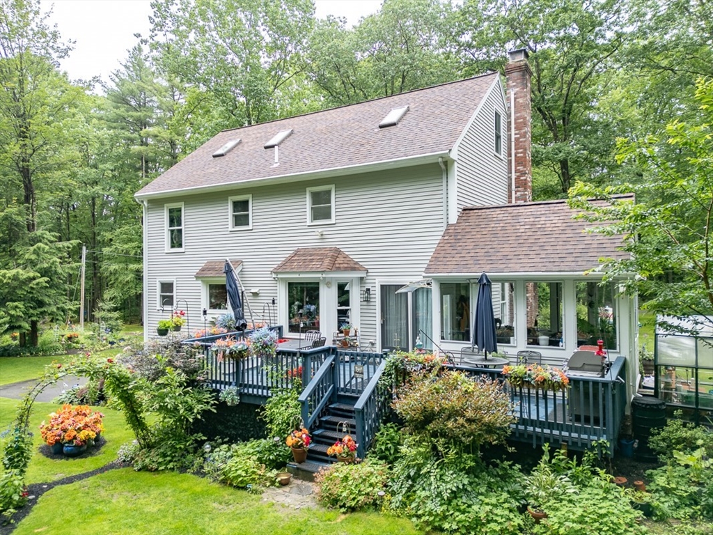 4 Wilderness Way Pepperell, MA 01463 - Photo 2 of 42 a front view of house with yard and green space