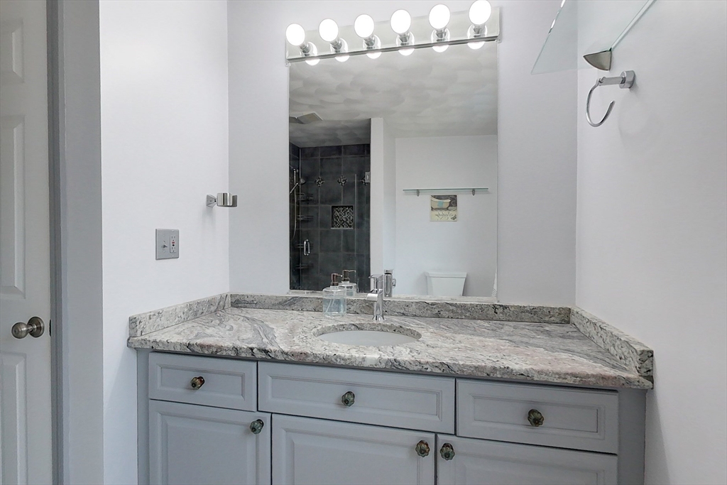 4 Wilderness Way Pepperell, MA 01463 - Photo 21 of 42 a bathroom with a granite countertop sink and a mirror
