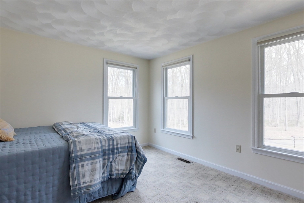 4 Wilderness Way Pepperell, MA 01463 - Photo 22 of 42 a bedroom with a bed and a window