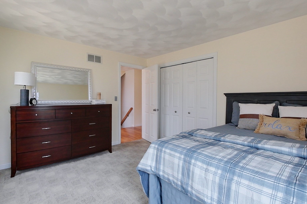 4 Wilderness Way Pepperell, MA 01463 - Photo 23 of 42 a bedroom with a bed and a closet