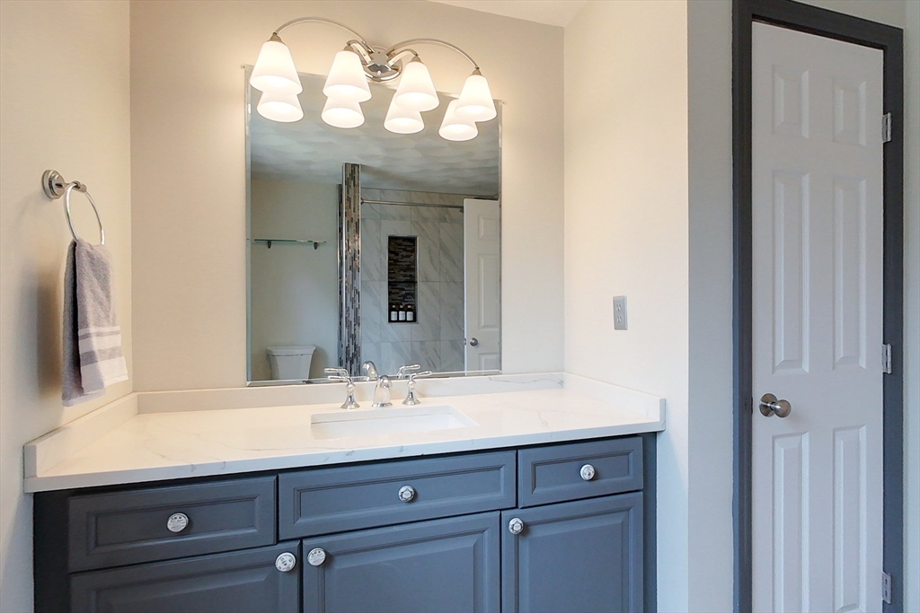 4 Wilderness Way Pepperell, MA 01463 - Photo 25 of 42 a bathroom with a sink and a mirror