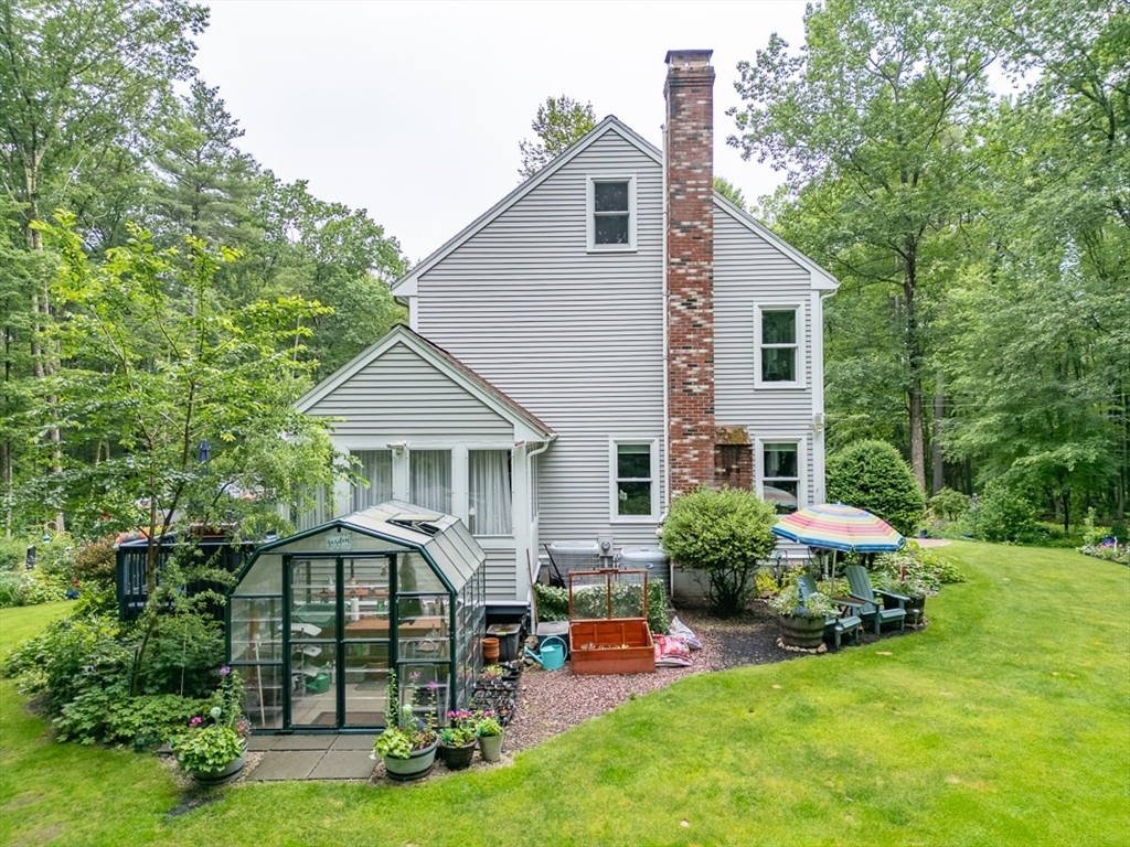 4 Wilderness Way Pepperell, MA 01463 - Photo 29 of 42 a front view of house with yard and outdoor seating