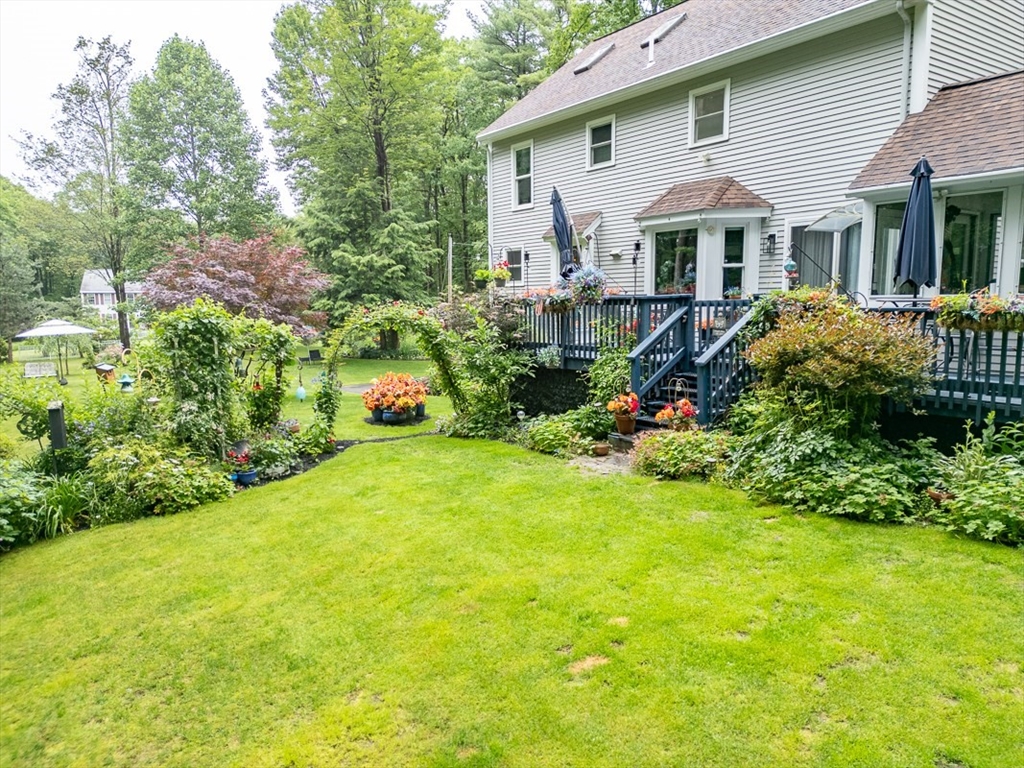 4 Wilderness Way Pepperell, MA 01463 - Photo 32 of 42 a front view of a house with a yard and trees