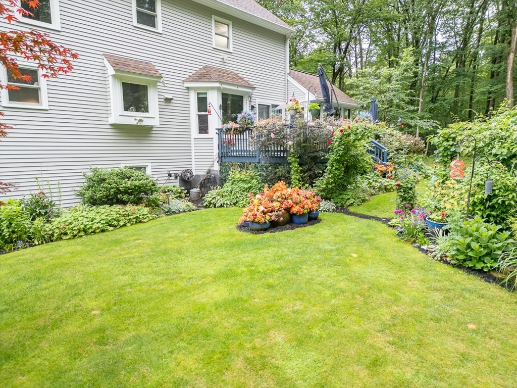 4 Wilderness Way Pepperell, MA 01463 - Photo 33 of 42 a front view of a house with a yard