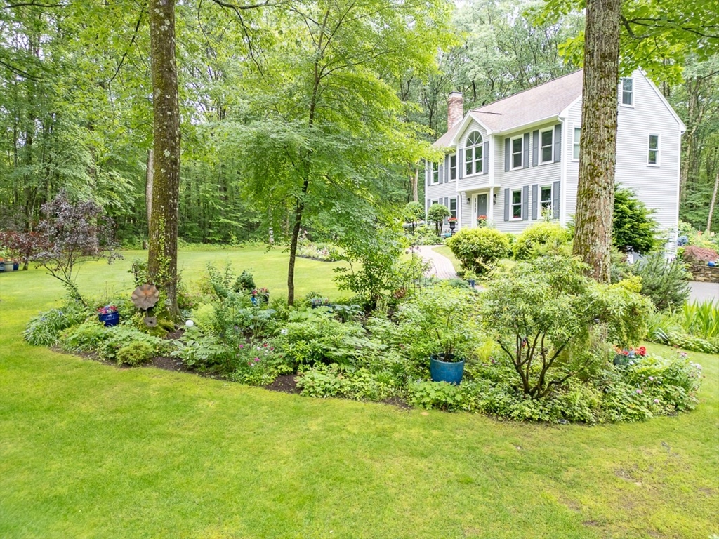 4 Wilderness Way Pepperell, MA 01463 - Photo 36 of 42 a front view of a house with a yard