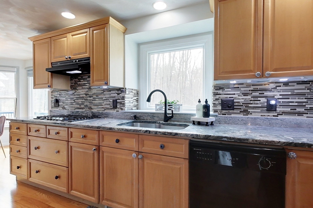 4 Wilderness Way Pepperell, MA 01463 - Photo 4 of 42 a kitchen with stainless steel appliances granite countertop a sink a stove and cabinets
