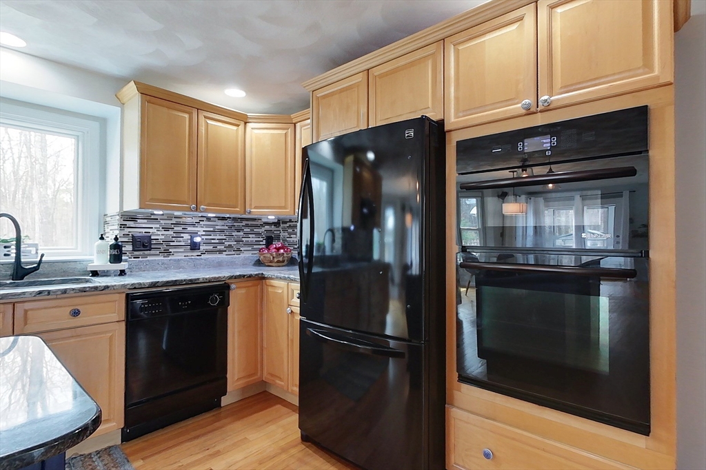 4 Wilderness Way Pepperell, MA 01463 - Photo 5 of 42 a kitchen with granite countertop stainless steel appliances and wooden cabinets