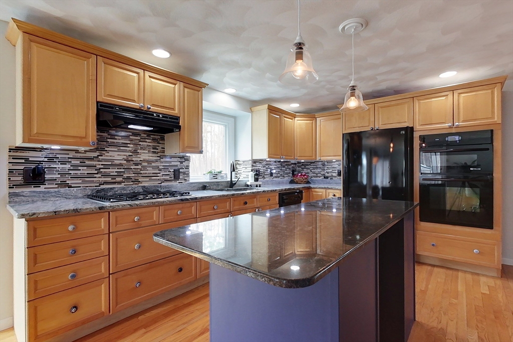 4 Wilderness Way Pepperell, MA 01463 - Photo 6 of 42 a kitchen with stainless steel appliances granite countertop a sink a stove and refrigerator