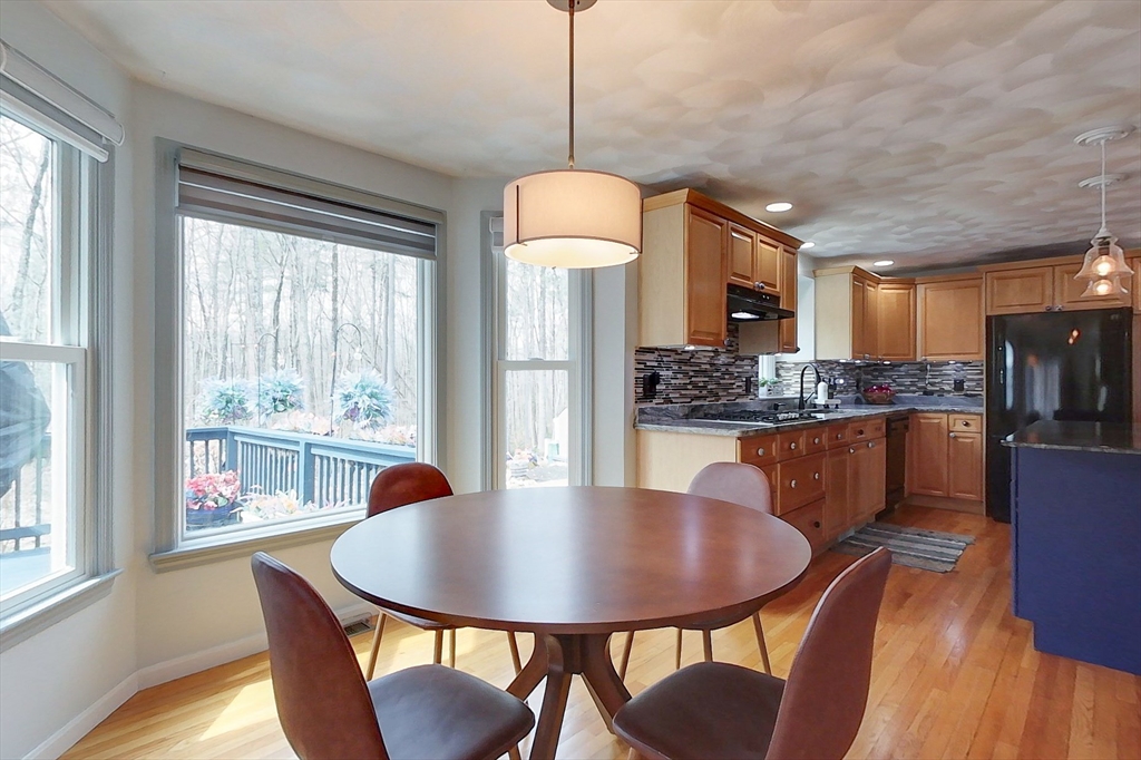 4 Wilderness Way Pepperell, MA 01463 - Photo 7 of 42 a kitchen with dining table and chairs