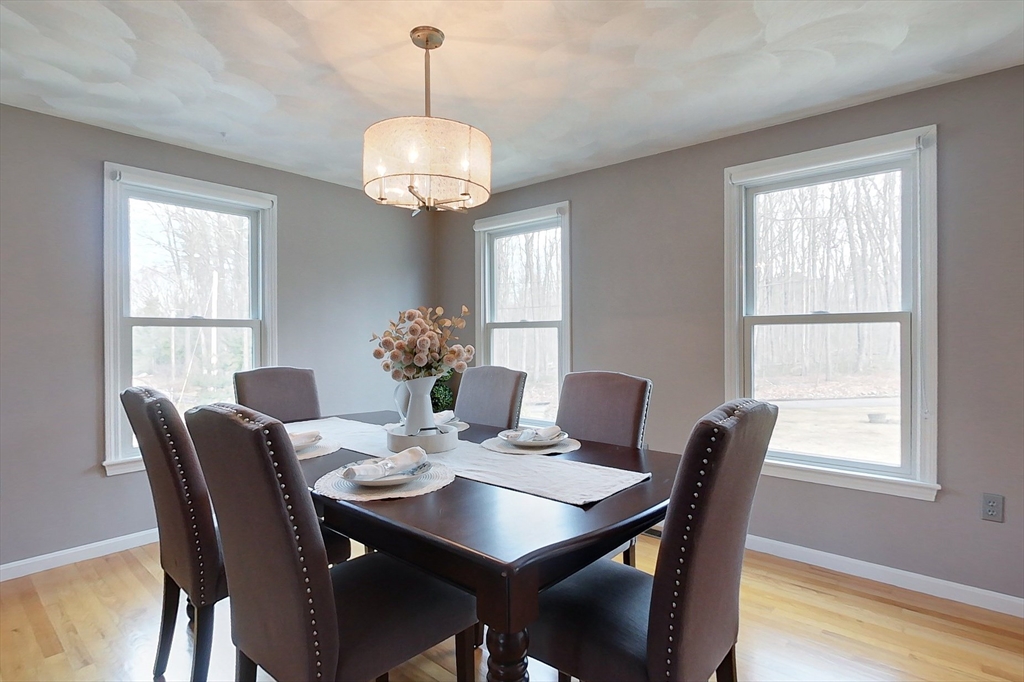 4 Wilderness Way Pepperell, MA 01463 - Photo 8 of 42 a view of a dining room with furniture window and wooden floor