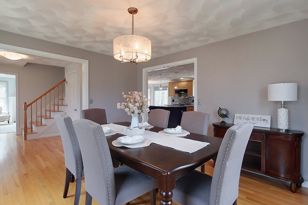 4 Wilderness Way Pepperell, MA 01463 - Photo 9 of 42 a view of a dining room with furniture wooden floor and chandelier