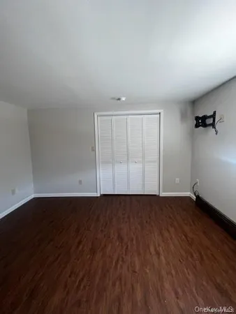 an empty room with wooden floor