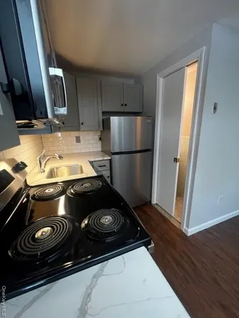 a kitchen with a stove and a refrigerator