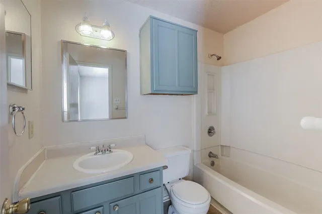 a bathroom with a sink toilet a mirror and shower