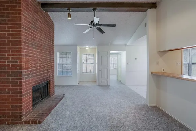 a view of an empty room with a fireplace