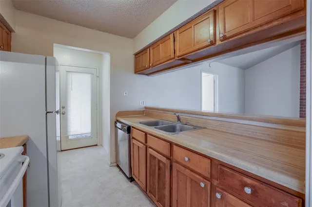 a kitchen with stainless steel appliances granite countertop a sink and cabinets