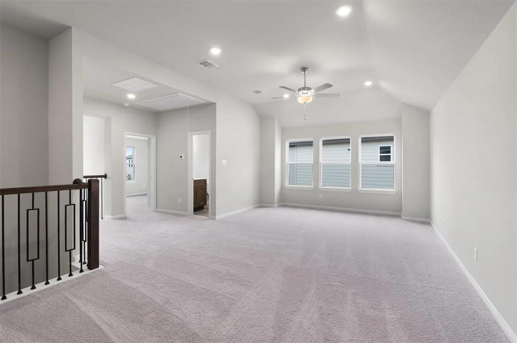332 Stellar Wind Drive Georgetown, TX 78628 - Photo 20 of 29 A spacious secondary living area features high ceilings, soft carpeting, and abundant natural light.