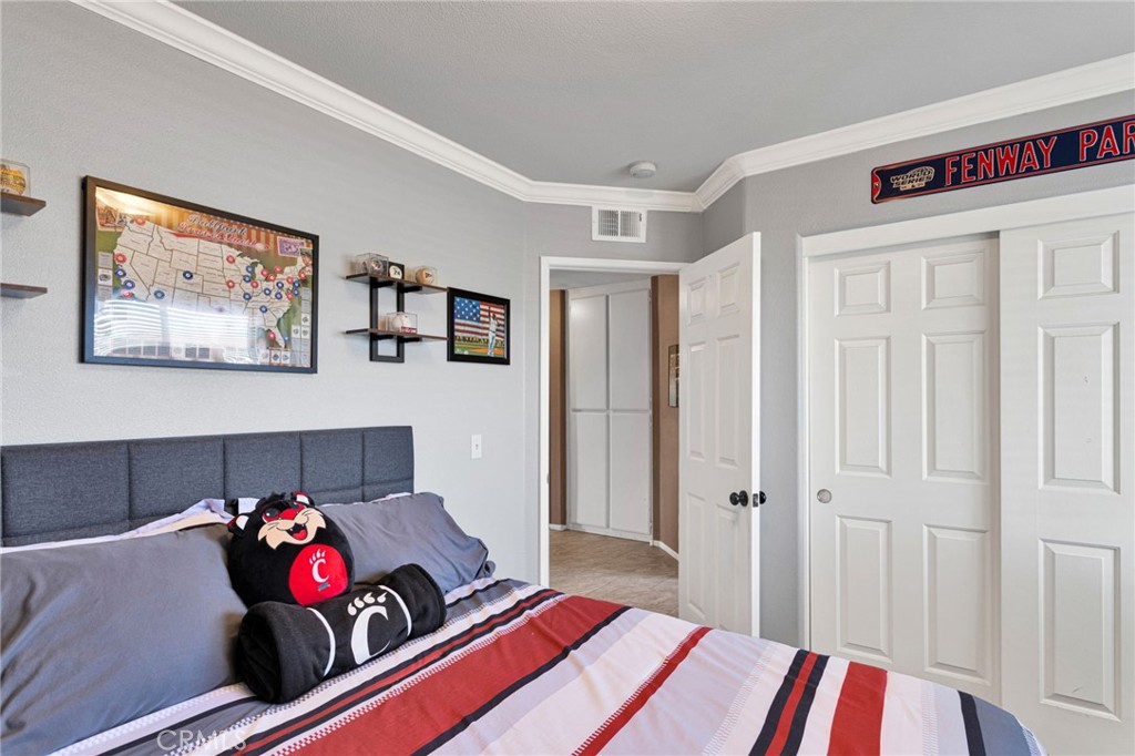 20403 Ochoa Road Apple Valley, CA 92307 - Photo 39 of 48 a bed room with a bed and a couch