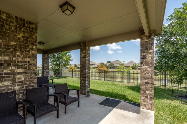 a view of a porch with furniture and garden