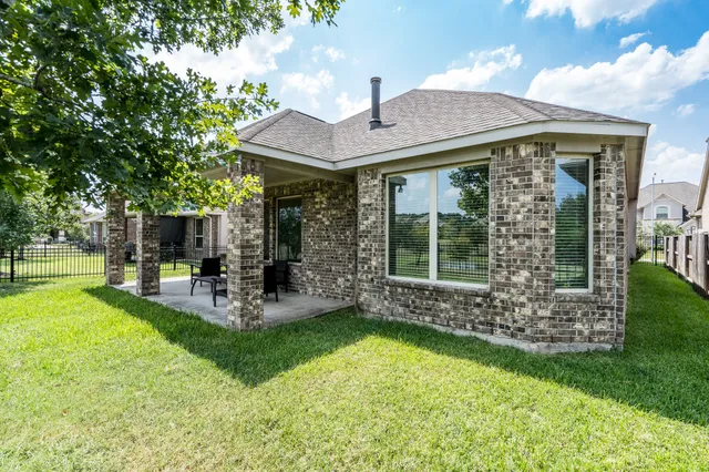 a view of a house with a yard porch and sitting area