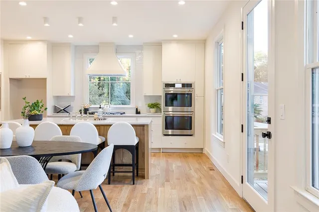 a view of a dining room with furniture kitchen and wooden floor