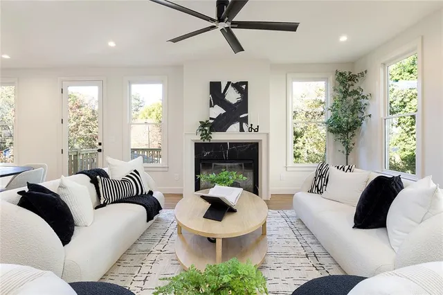 a living room with furniture a window and a fireplace
