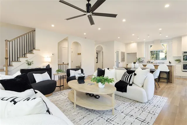 a living room with furniture kitchen view and a table