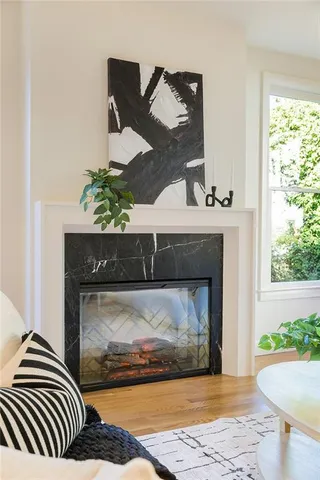 a living room with a fireplace and a floor to ceiling window