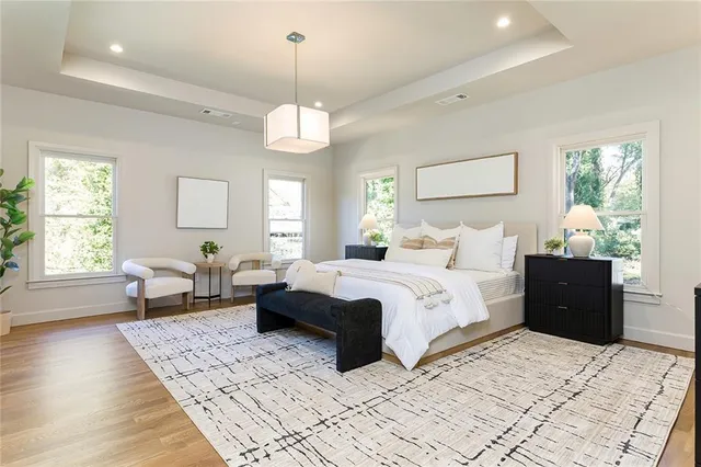 a bedroom with bed and wooden floor