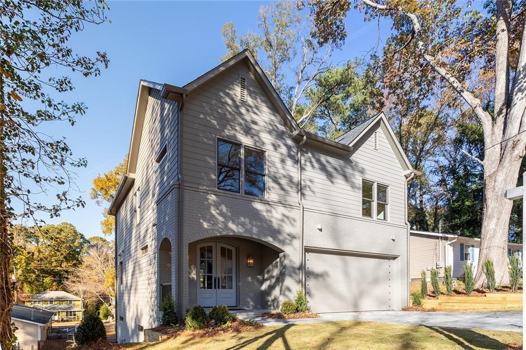 3156 Zion Street Scottdale, GA 30079 - Photo 3 of 48 a view of a white house with a large tree and a yard