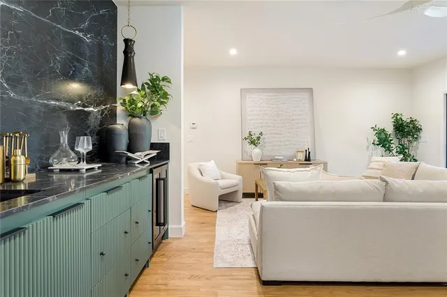 a living room with furniture and flowers