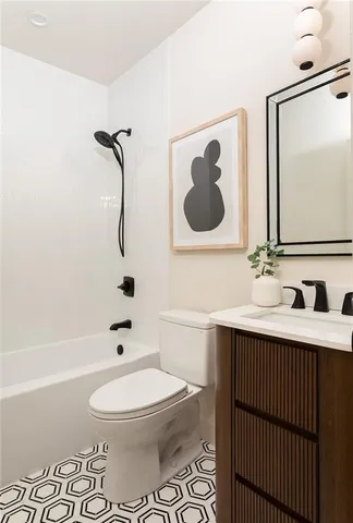 a bathroom with a toilet sink a mirror and shower