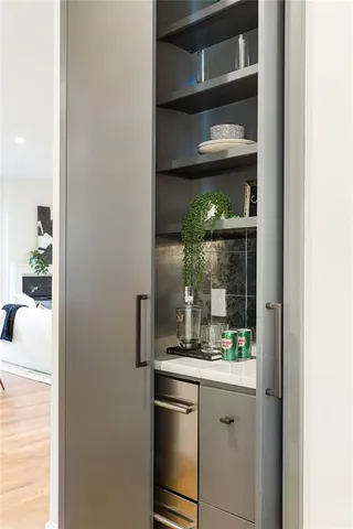 a kitchen with a refrigerator and cabinets